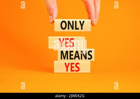 Only yes means yes symbol. Concept words Only yes means yes on wooden blocks on a beautiful orange table orange background. Businessman hand. Business Stock Photo