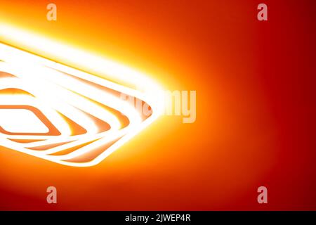 Bright LED lamp glow on the red ceiling. Stock Photo