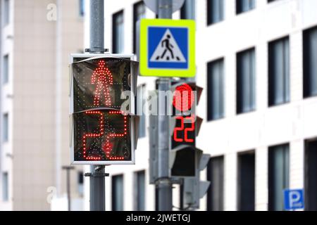 Red traffic lights on a city street. Countdown at the pedestrian crossing Stock Photo