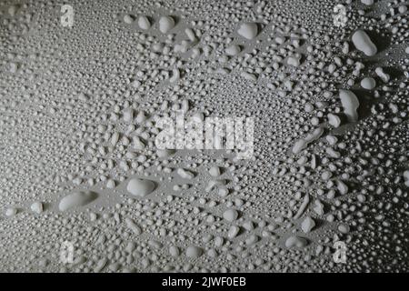 Gray drops of water, dew on smooth surface Stock Photo