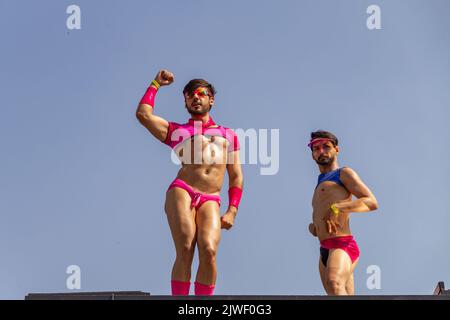 Goiânia, Goias, Brazil – September 05, 2022: Two young people dancing on top of an electric trio. Photo taken during the LGBT Parade in Goiania. Stock Photo
