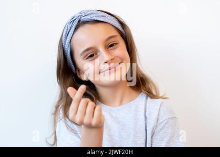 supportive child cute girl finger heart gesture Stock Photo