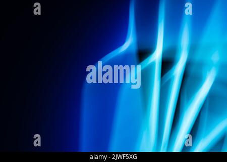 Light from a led lamp in motion in the dark. Technology theme. Abstract banner in blue colors. Back. Stock Photo