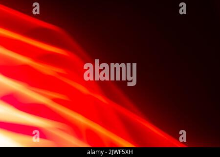 Abstract glowing red waves on a dark background. Banner. Backdrop Stock Photo