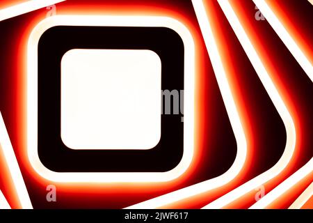 Red-white LED lamp glowing on the ceiling. Technology abstraction. Glowing square and lines. Background Stock Photo