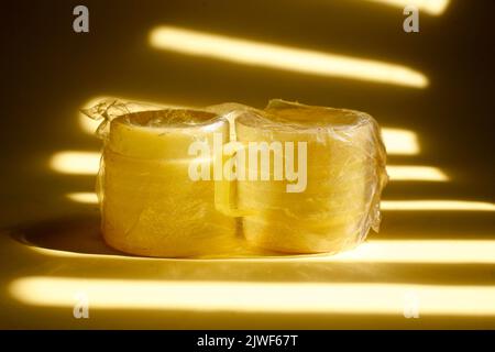 yellow plastic cup covered with transparent plastic Stock Photo