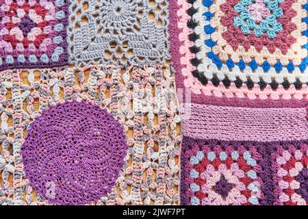 Colourful patchwork abstract background. Different pieces, knitted and crocheted are into one canvas Stock Photo