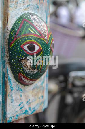 mask on display; antique; traditional face; brow, cultural mask, old mask; image with a bokeh; Traditional mask carved on wood on display in Galle Stock Photo