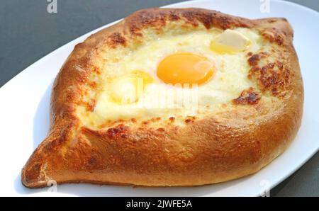 Closeup Freshly Baked Adjarian Khachapuri, Cheese and Egg Filled Traditional Georgian Bread Stock Photo