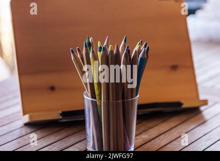 Dry paint pencils with wooden background. Selective focus on pencils. Stock Photo