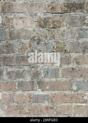 Full frame dark coarse brick wall background with copy space Stock Photo