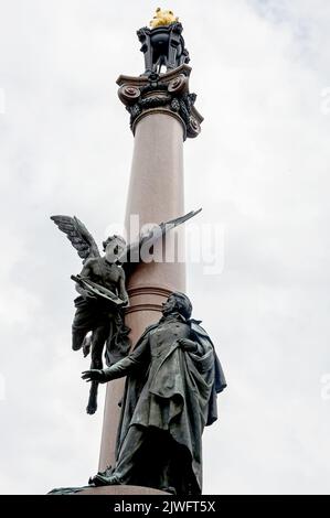 Monument to polish poet Adam Bernard Mickiewicz with winged genius of poetry with lyre and golden blaze on top in Lviv, Ukraine Stock Photo