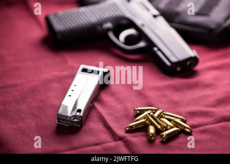 Black semi automatic pistol, 9mm bullets and a magazine Stock Photo