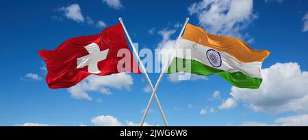 crossed national flags of India and switzerland flag waving in the wind ...