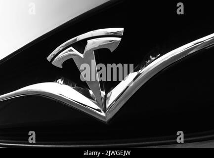 Tesla logo emblem on car front, closeup Stock Photo