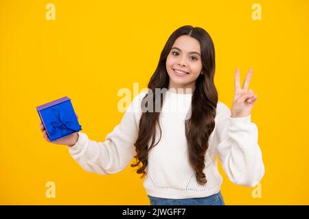 Cute teenager child girl congratulate with valentines day, giving romantic gift box. Present, greeting and gifting birthday concept. Happy face Stock Photo