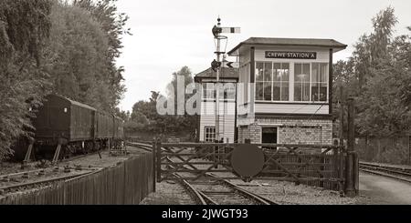 Sepia traditional Victorian railway signalbox, and rolling stock at Crewe Station A, at Cheshire, England, UK, CW1 2DB, in sepia Stock Photo