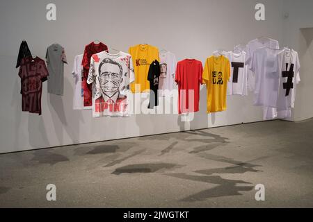 (Editor's Note: Editorial Use Only)  An installation of 'T-shirts with designs' seen during the exhibition 'Giro grafico. Como en el muro la hiedra', at the Reina Sofia Museum. This exhibition was carried out by the Network of Conceptualisms of the South, makes a tour of graphic initiatives from the 1960s to the present on politically oppressive contexts of urgencies in Latin America. Graphic spin. As on the wall, the ivy is the result of a long process of collective research carried out by the Red de Conceptualismos del Sur in collaboration with the Reina Sofía Museum. The exhibition proposes Stock Photo