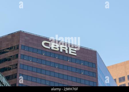 Close-up of CBRE logo on blue sign in window of a building, San ...