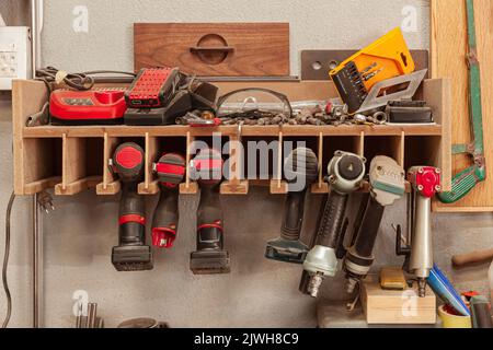 Wood workshop with many hand tools on plank wall Stock Photo