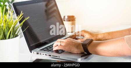Web application development. programmer woman writing program code sitting at workplace in office, software developer hands coding HTML programming wi Stock Photo