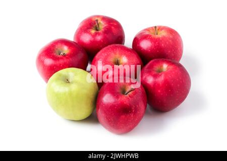 One green apple among red ones isolated on white Stock Photo