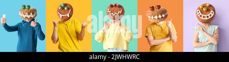 People with funny monster cookies instead of their heads on color background. Halloween celebration Stock Photo