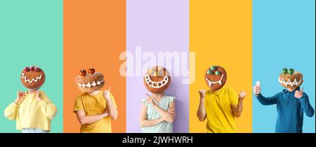 People with funny monster cookies instead of their heads on color background. Halloween celebration Stock Photo