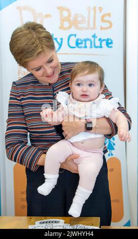 First Minister Nicola Sturgeon with Millie Anderson, age 10 months, during a visit to Dr Bell's Family Centre in Leith, Edinburgh, to launch the Programme for Government, setting out the actions the Scottish Government intends to take in the next year and beyond. Picture date: Monday September 5, 2022. Stock Photo