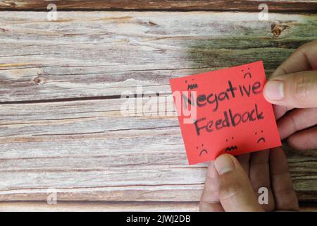 How to handle customer negative feedback concept. Hand holding red note with written word with copy space. Stock Photo