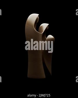 An abstract stylized wood carving depicting a christian christmas nativity scene featuring mary, joseph and baby jesus - 3D render Stock Photo