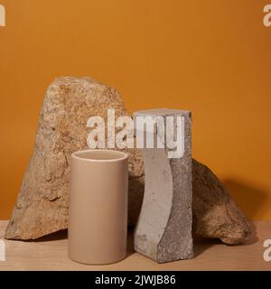 A podium made of geometric figures of concrete and porcelain for cosmetic products. Rectangular podiums with shadows on a yellow background. Layout for product presentation. High quality photo Stock Photo