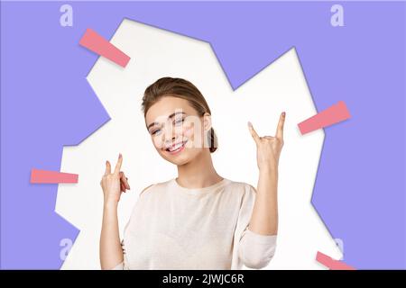 smiling young woman showing rock and roll hand Stock Photo