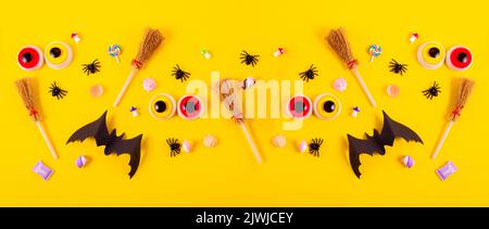 Happy Halloween Banner background with Flat lay composition of Pumpkins, Spiders, and Bats. Halloween Festive backdrop with copy space. Stock Photo