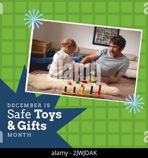 Father looking at baby playing with toy block at home and december is safe toys and gifts month text Stock Photo