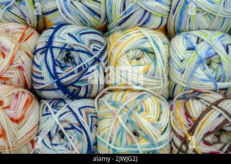 Close-up woolen threads multicolored in a basket, top view Stock Photo