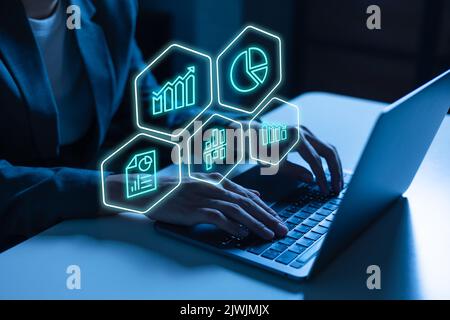 Male trader in business suit using laptop with virtual digital interface screen of investment and financial report and security market trading chart icons Stock Photo
