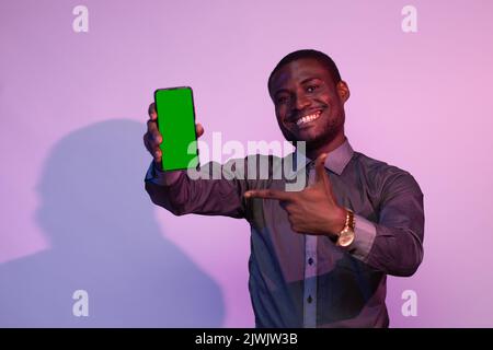 african man excitedly showing his phone screen Stock Photo