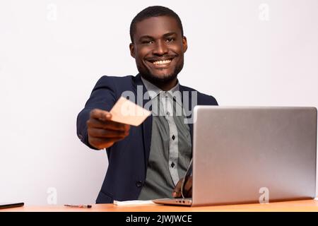african businessman giving someone a check Stock Photo