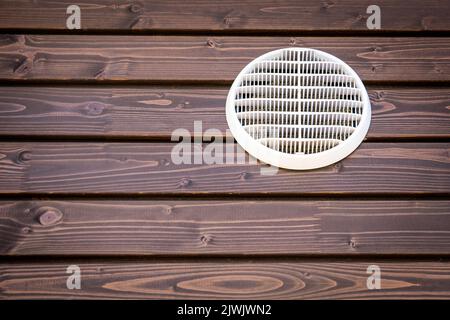 White ventilation grill on a wooden background, building facade. Stock Photo