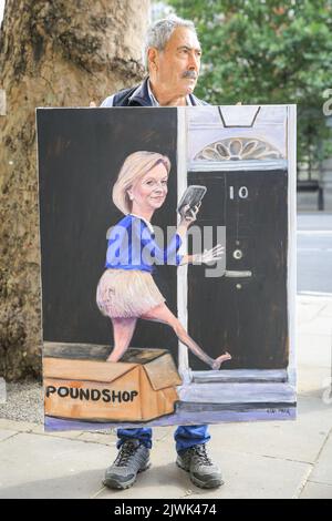 London, UK. 06th Sep, 2022. Sartirical artist and painter Kaya Mar with one of his works, depicting new Prime Minister Liz Truss entering 10 Downing Street arriving in a Poundshop box. Credit: Imageplotter/Alamy Live News Stock Photo