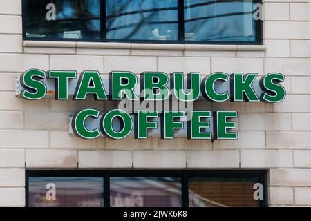 STARBUCKS COFFEE sign at storefront. Starbucks locations serve worldwide hot and cold drinks, all sorts of. HALIFAX, NOVA SCOTIA, CANADA - AUG 2022 Stock Photo