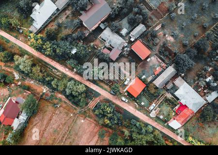 Top-down view over rural village  and countryside road in East Europe Stock Photo