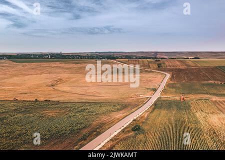 Aerial view over  sunflower field patched farmland  Agricultural wheat fields in a rural area, in Europe Stock Photo