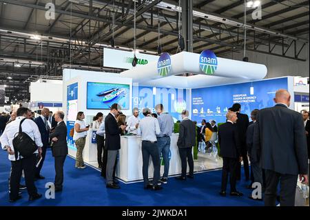 MILAN, ITALY - SEPTEMBER 6, 2022: a view of the Snam stand during Gastech 2022 trade show event in Milan Fair. Visitors and people in the hall walk through exhibitors stands and exhibit booths. Stock Photo