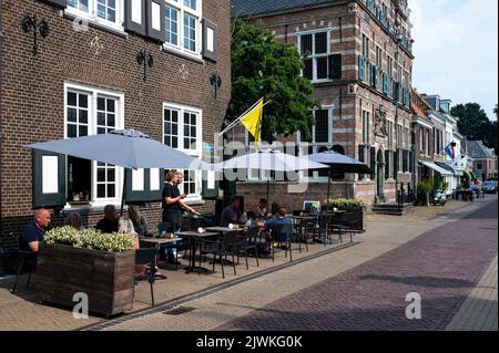 Naarden, North Holland,  The Netherlands - 07 20 2022 - People on terraces in the old village square Stock Photo