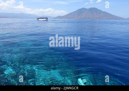 Indonesia Alor Island - Reef edge and local ferry Stock Photo