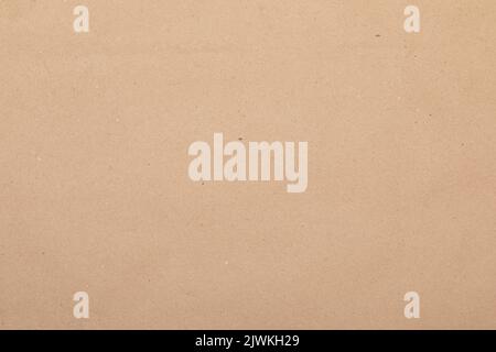 Sheet of brown kraft paper textured background. Cardboard made of recycled paper for packaging products Stock Photo