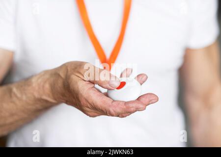 Unrecognizable senior man pushing panic button on emergency equipment Stock Photo