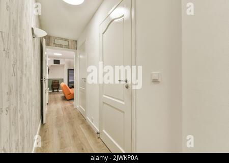 Narrow corridor with doors and lamp Stock Photo